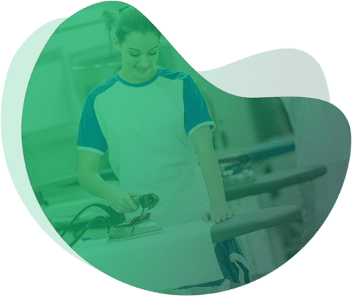 Woman ironing clothes in laundry room